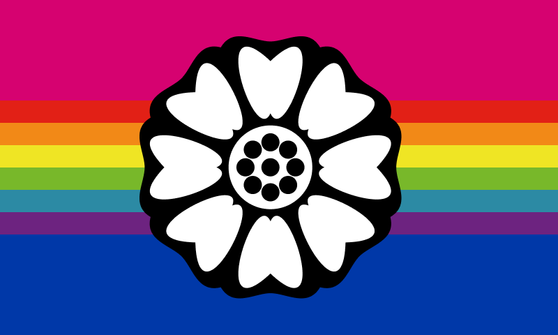 A flag with horizontal stripes in different widths. A pink stripe is a third the height of the flag, then come 6 thin stripes in red, orange, yellow, green, teal and purple which together take up one third the height, and a blue stripe that is again third the height. In the center is an illustrated lotus flower, spanning into all three thirds.